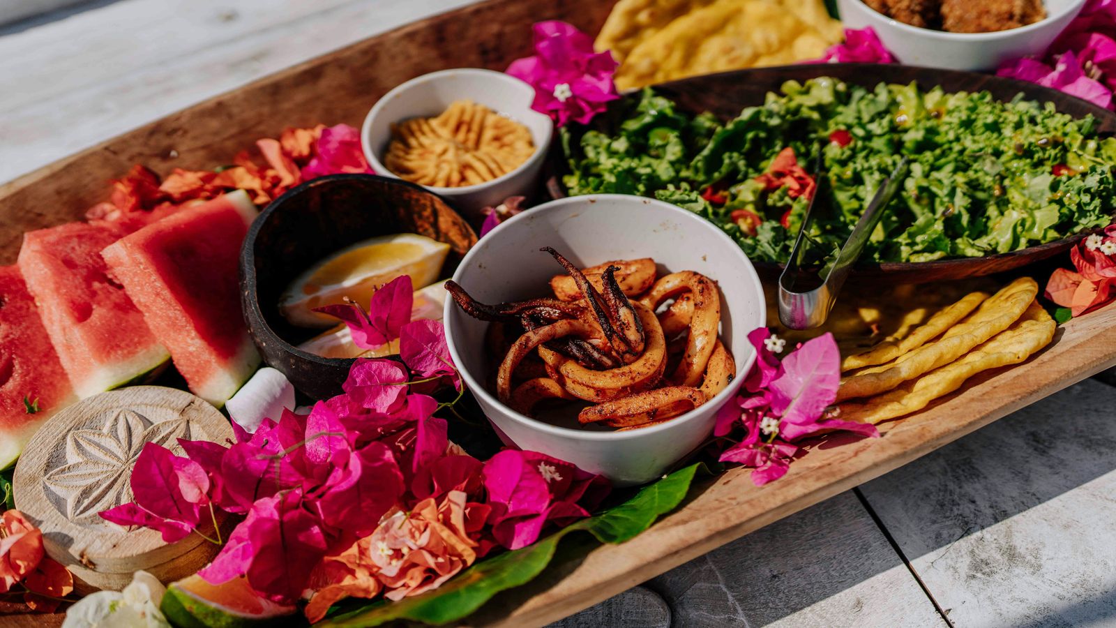 A Swahili platter of grilled seafood, fresh fruit and salads served in Zanzibar